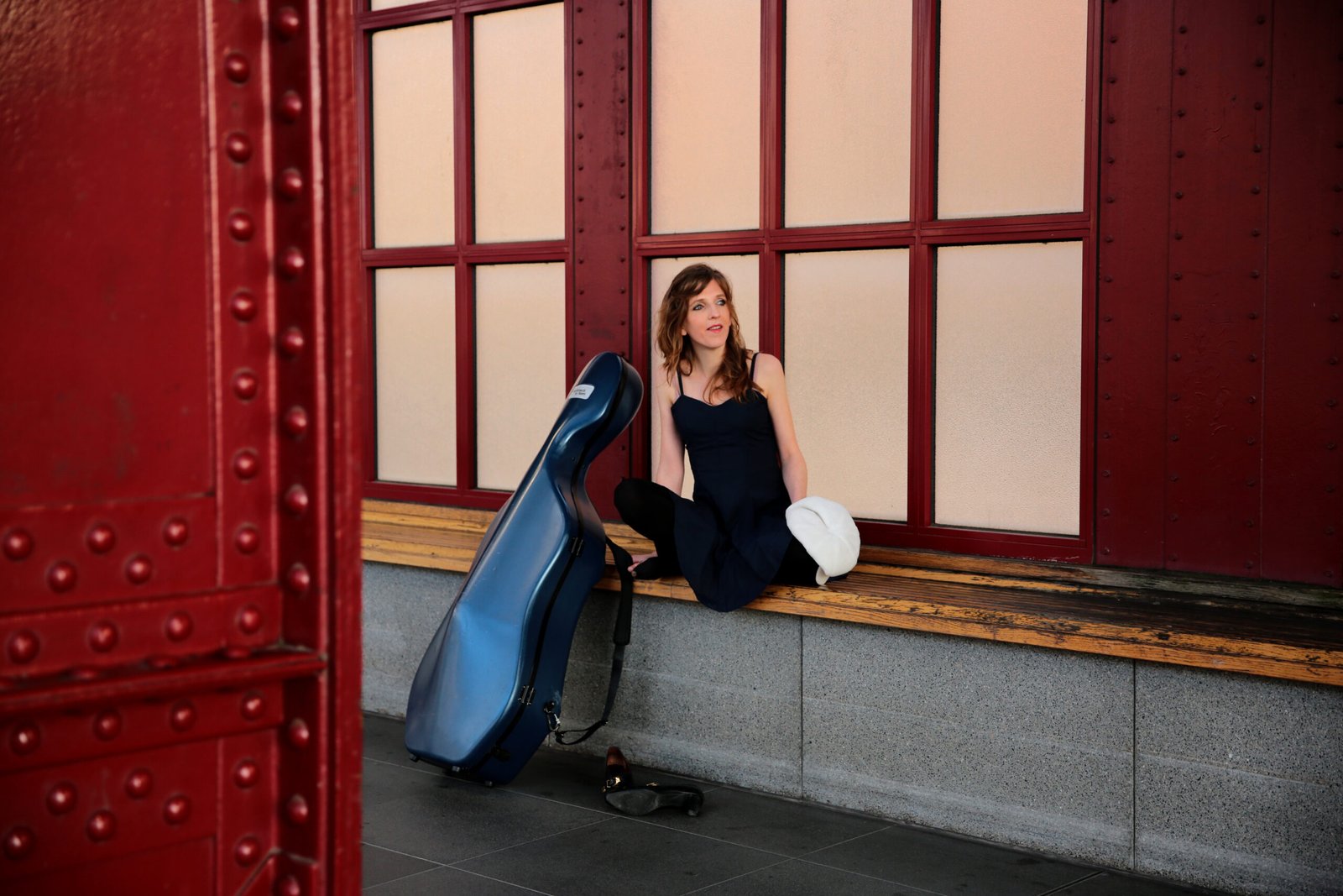 Dutch cellist Lidy Blijdorp seated with her cello at Antwerpen Central Station